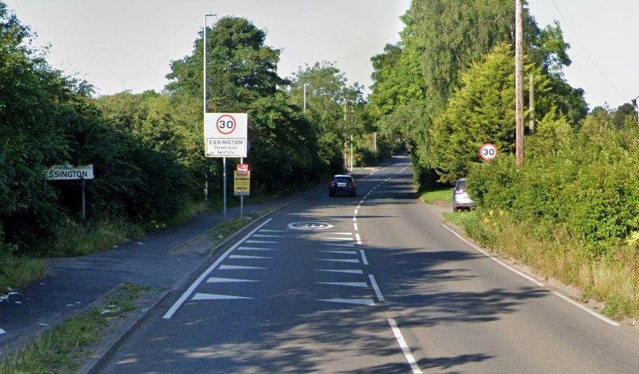 An image of Hobnock Road as it enters the village of Essington, with two signs naming the village, two 30mph speed limit signs and speed reduction road markings.