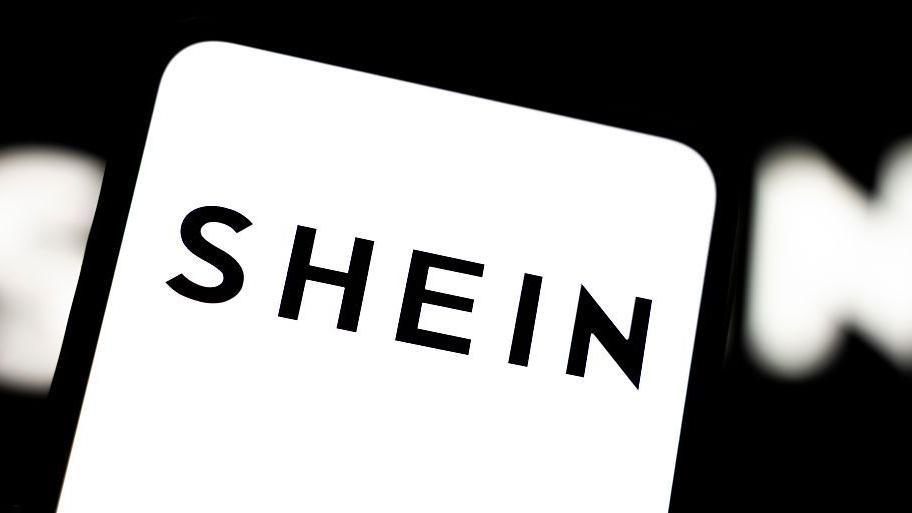 Black Shein logo on a white background on a smartphone screen