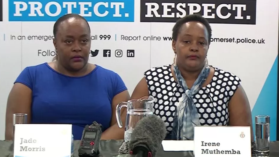 Ms Morris and Ms Muthemba at a desk with microphones at a police press conference