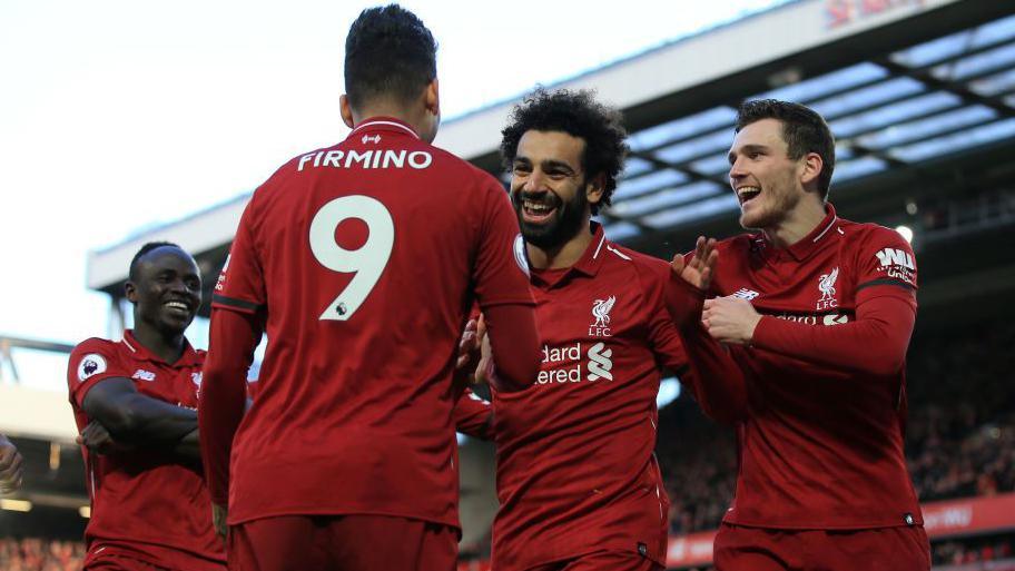 Mohamed Salah celebrates a Liverpool goal with team-mates Sadio Mane, Roberto Firmino and Andy Robertson