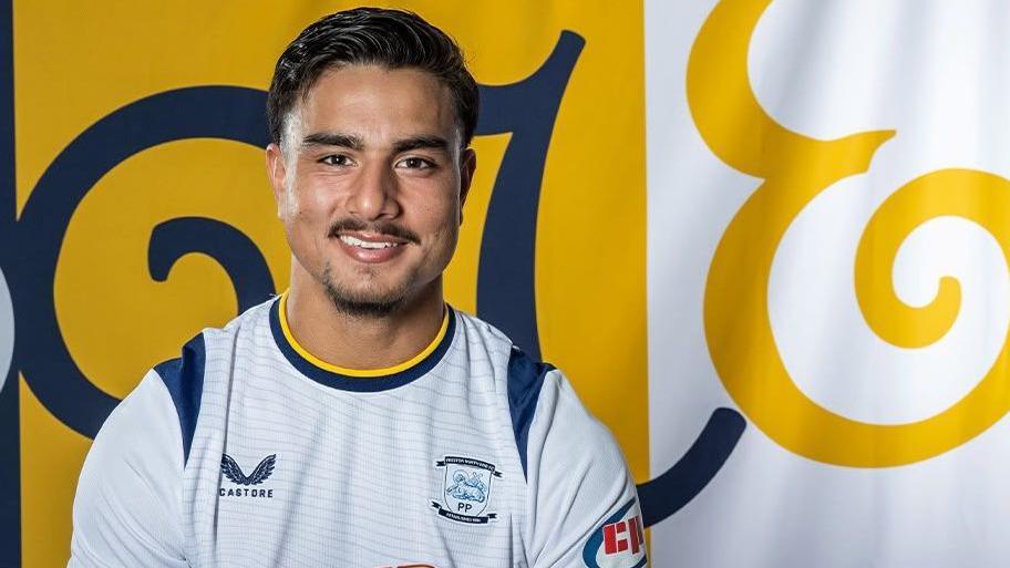 Jusef Erabi poses in a Preston shirt