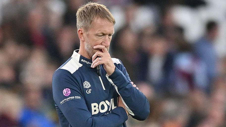 Graham Potter holds his hand over his mouth