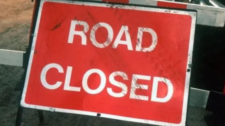 A red sign which reads road closed in white lettering