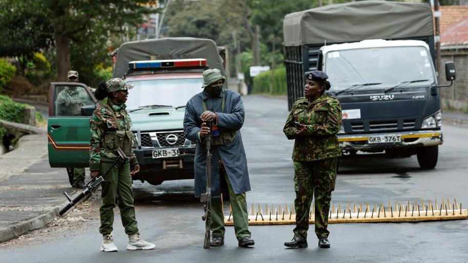 Members of the Kenyan police are seen stationed outside State house in Nairobi on June 27, 2024.