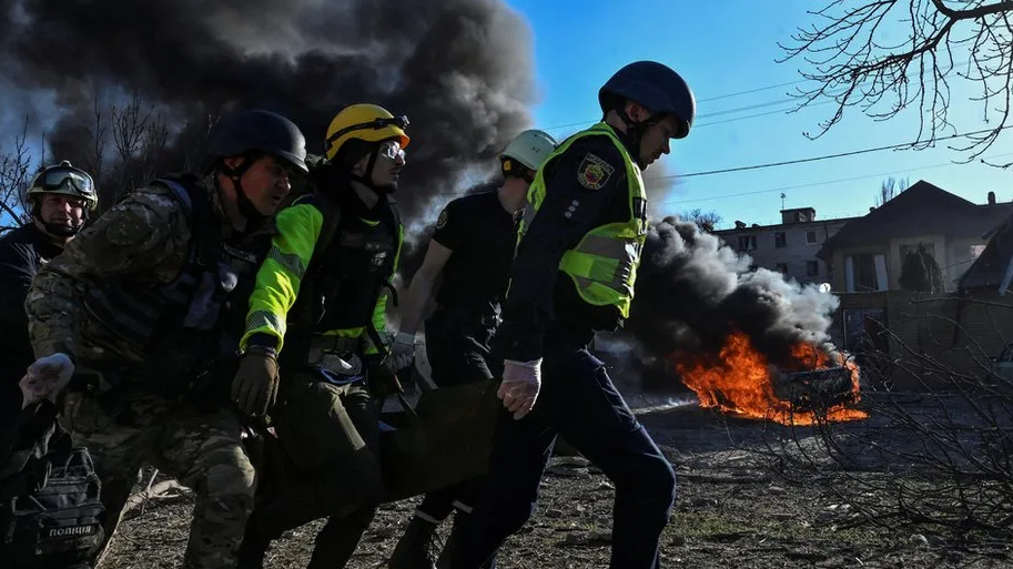 Emergency workers carry an injured woman at the site of a Russian missile strike in Zaporizhzhia in April