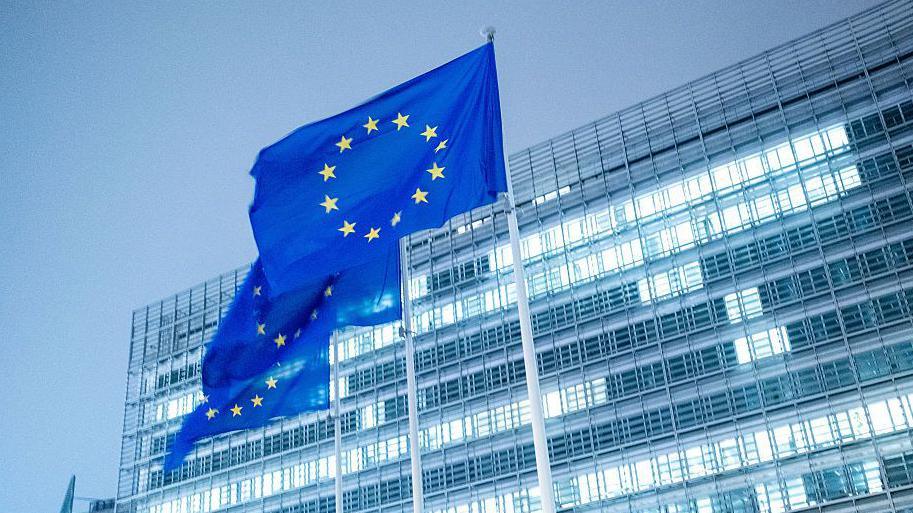 EU flags outside a European Commission building in Brussels