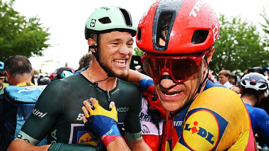 Jonathan Milan celebrates with team-mate Jasper Stuyven after winning stage 17 of the 2025 Tour de France