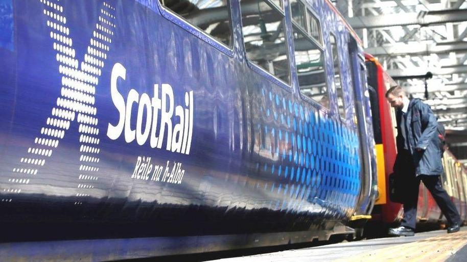 man boarding scotrail train