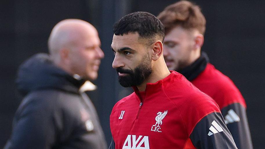 Mohamed Salah wearing a Liverpool training top