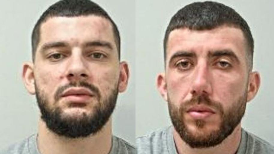 Two mugshots side by side of two young men. They each have short beards and clipped hair and are wearing grey t-shirts. 