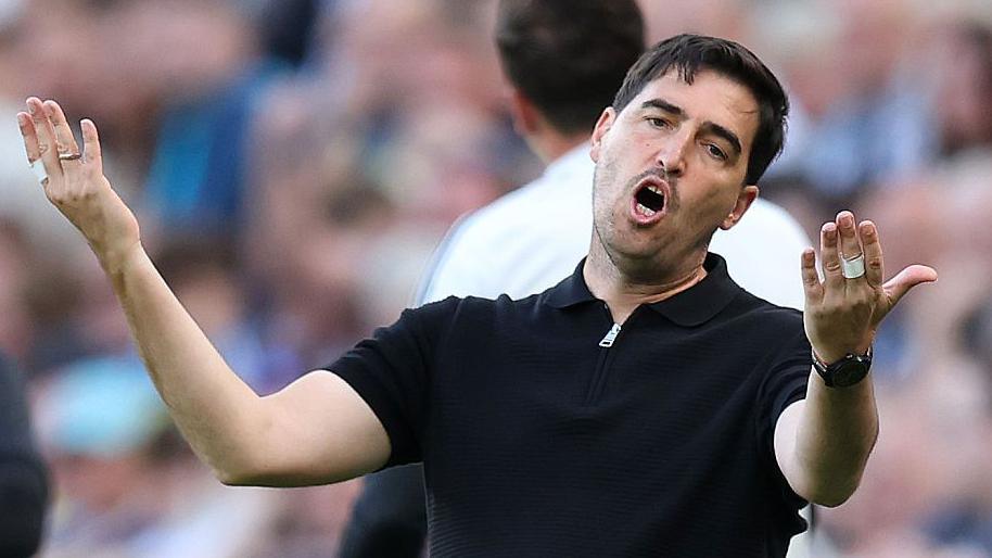 Liverpool manager Andoni Iraola raises his arms and looks frustrated during their Premier League game against Newcastle