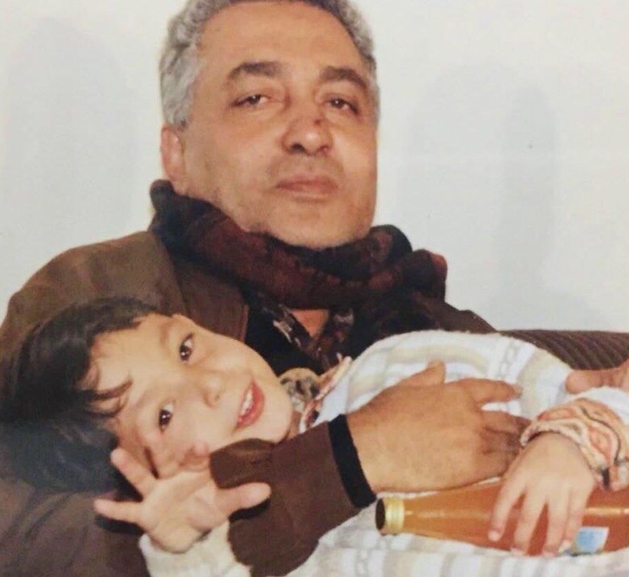 Dorgham Abusalim pictured as a child sitting in his fathers lap