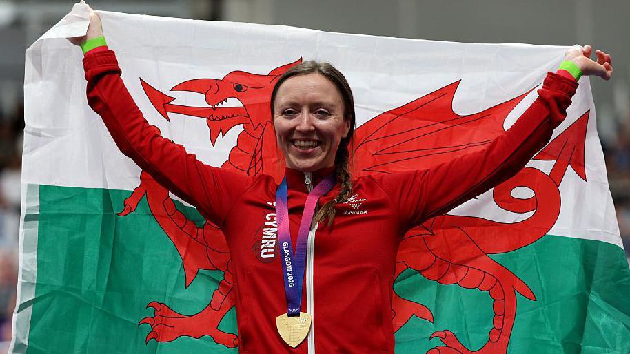 Anna Morris with her gold medal and Dragons flag