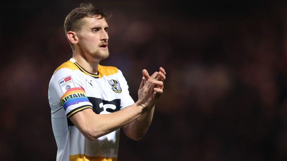 A close up of Nathan Smith clapping the fans after a game for Port Vale