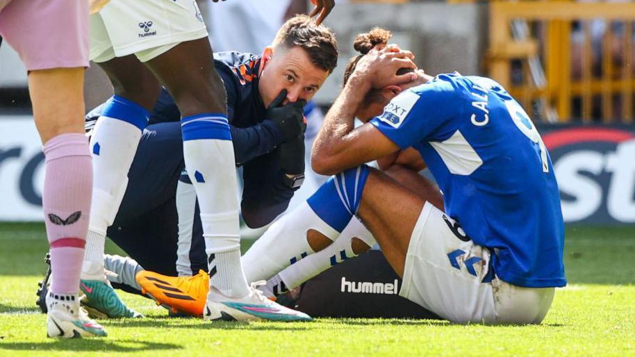 Dominic Calvert-Lewin looks frustrated after an injury while playing for Everton