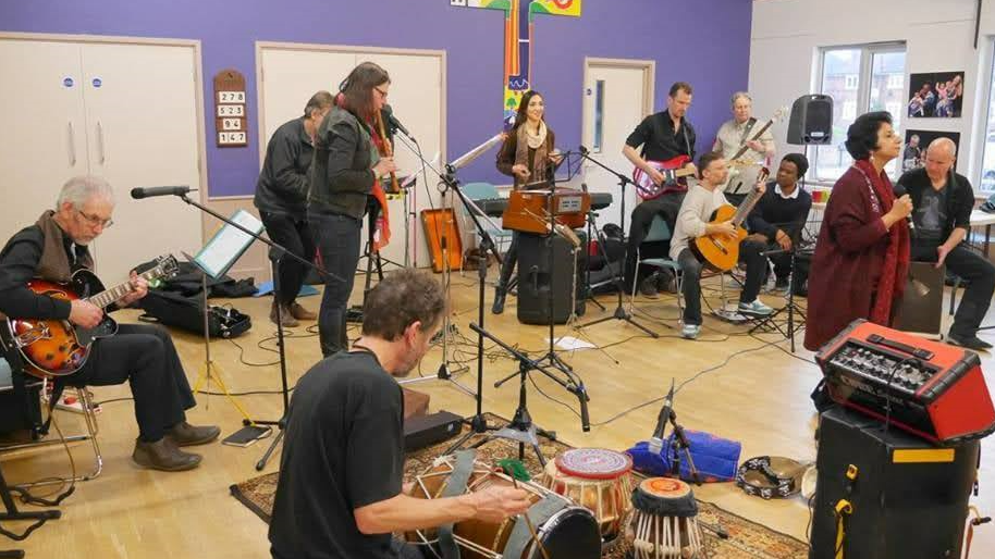 Performers from Confluence Collective Oxford singing and playing musical instruments on one of their sessions.