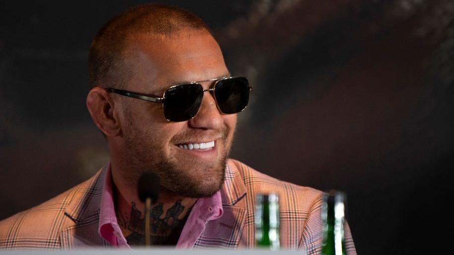 Conor McGregor in sunglasses smiling