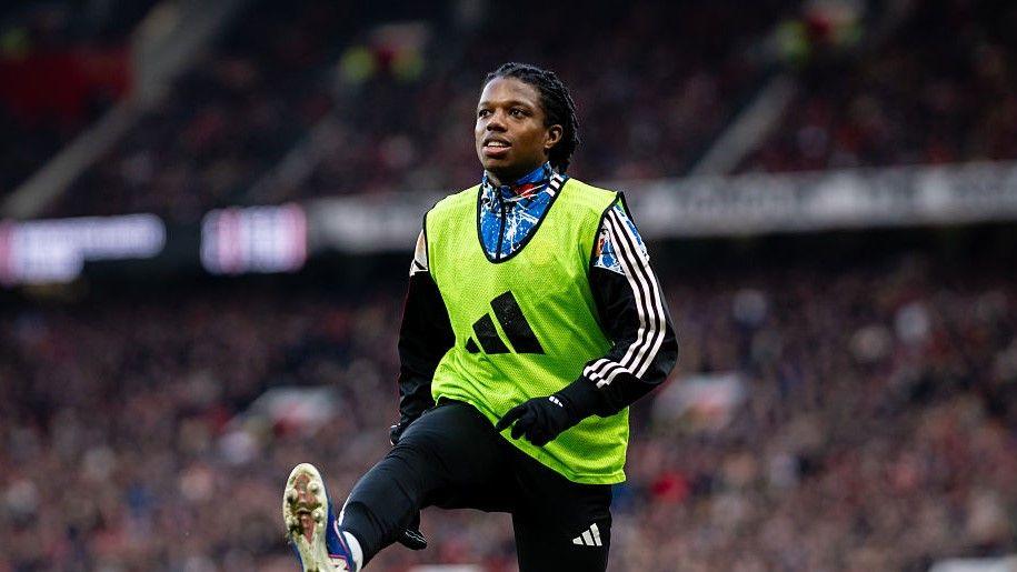 Manchester United defender Tyrell Malacia warms up during the Premier League victory over Fulham
