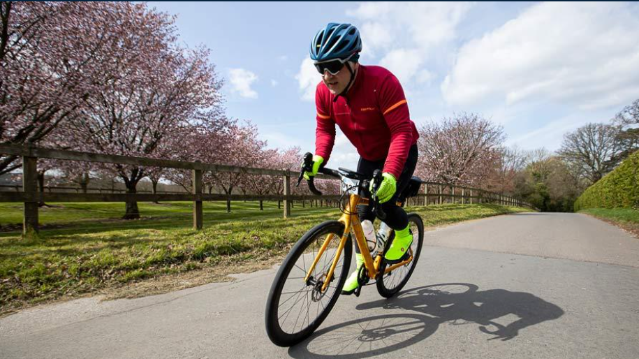 cyclist wearing red jumper and blue helmet