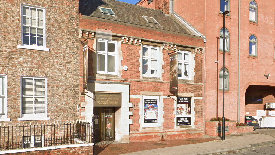 York Army Museum, a red-brick building with posters to welcome visitors.