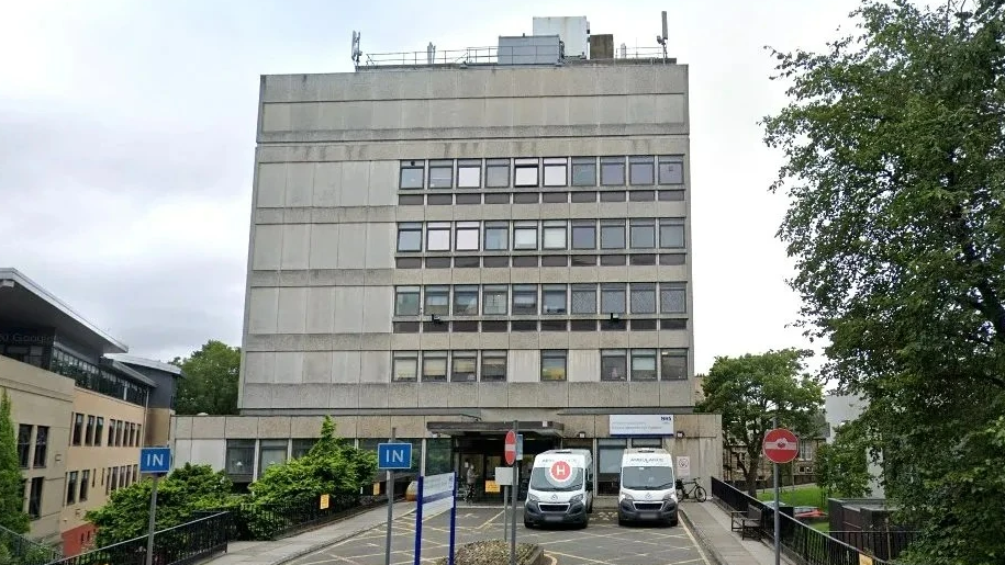 An outside view of the Princess Alexandra Eye Pavilion with ambulances outside 