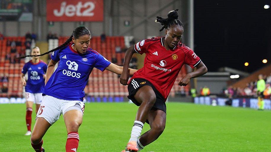 Manchester United's Melvine Malard battles for possession with Ylinn Tennebo of Valerenga in the Champions League encounter