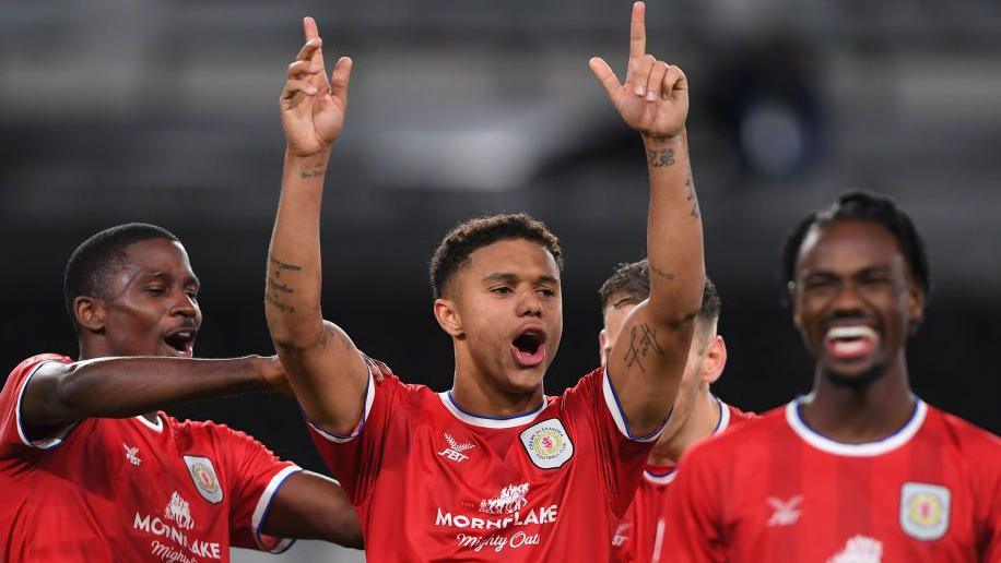 Rio Adebisi celebrates with his Crewe team-mates