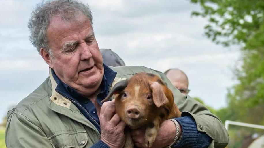 Jeremy Clarkson holding a baby pig