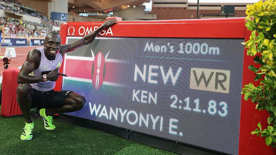 Emmanuel Wanyonyi takes a photograph next to the world record screen after winning the 1,000m in Monaco 