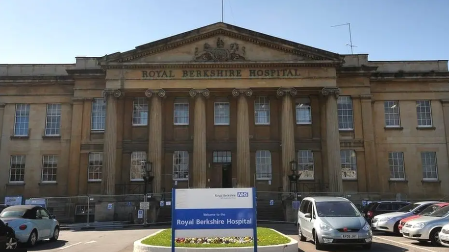 Royal Berkshire Hospital - yellow stone brick building with carpark out front.