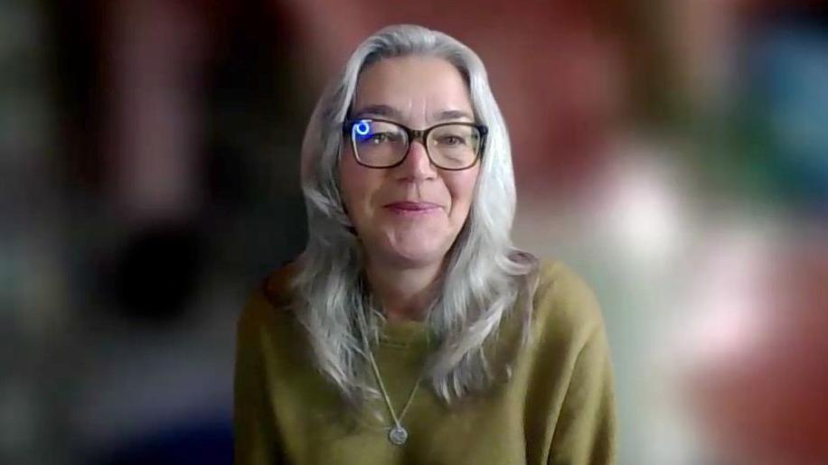 Professor Ruth Garside from the University of Exeter Medical School, who is wearing a green jumper and is smiling while looking at the camera.