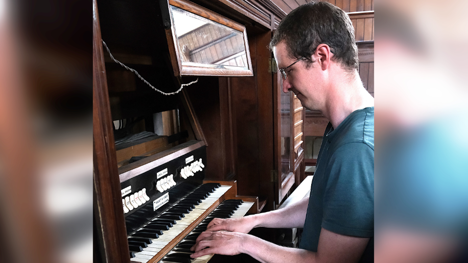 Y saer organ Kingsley Robinson yn chwarae organ Capel Rhondda