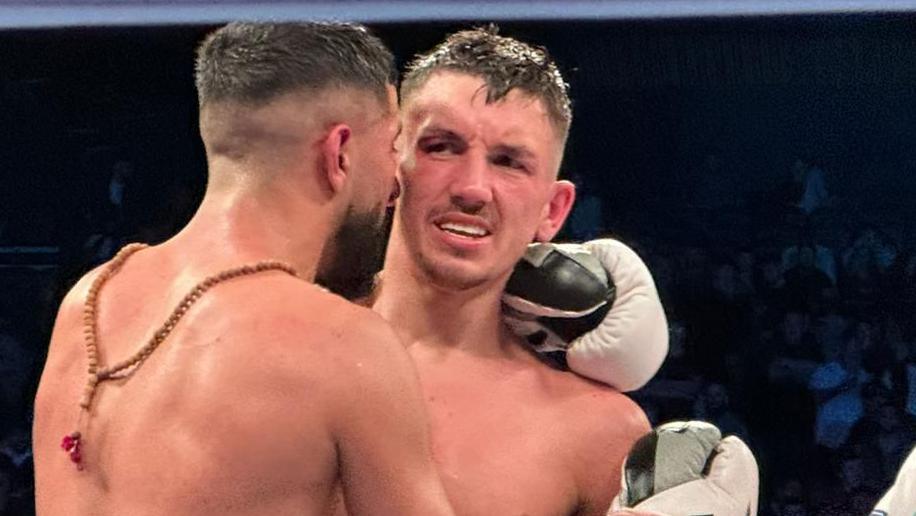 Liam Davies is consoled by the victor Shabaz Masoud after the first loss of his pro career