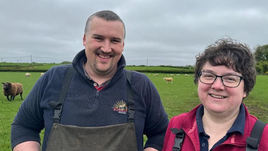 sheep farmers in a field