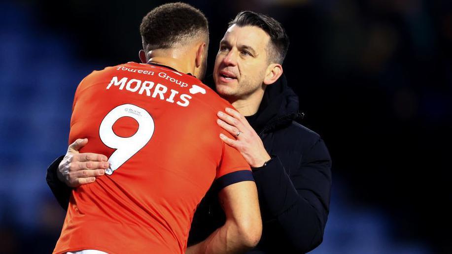 Luton Town manager Matt Bloomfield hugs centre-forward Carlton Morris after a game.