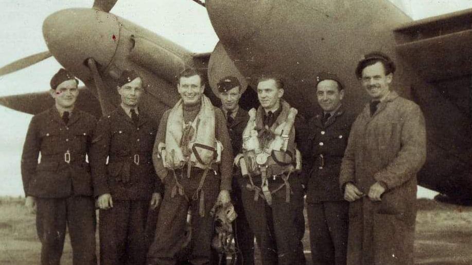 Members of the Polish Air Force's 307 Squadron stand in front of a plane while serving in Exeter.