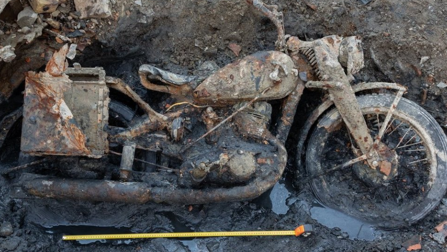 Image of motorcycle embeded in mud. 
