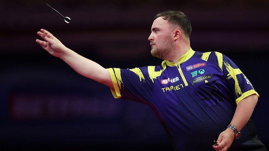 World champion Luke Littler throws a dart