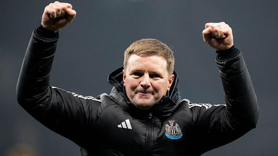 Eddie Howe celebrates with his arms in the air
