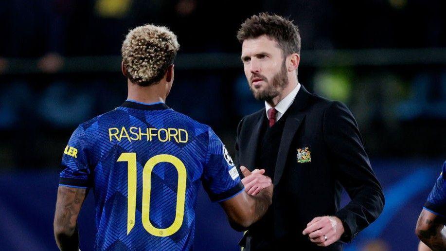 Marcus Rashford and Michael Carrick (right)