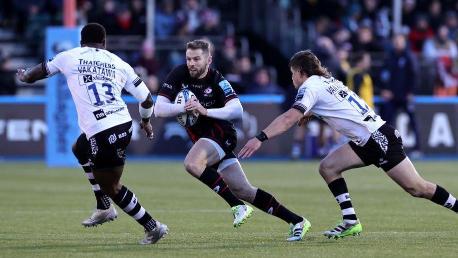 Virimi Vakatawa and Benhard Janse van Rensburg attempt to stop Elliot Daly while playing for Bristol in November 2023