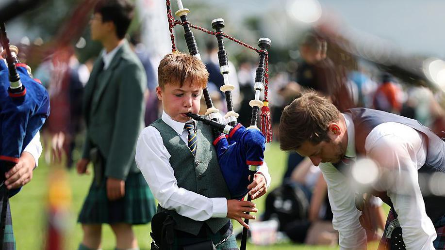 A boy prepares for the World Pipe Band Championships