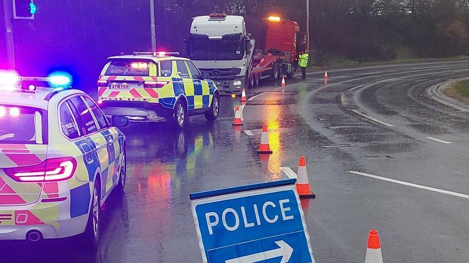 Police by a lorry that has lost its load in Felixstowe