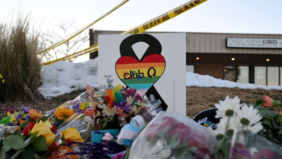 People leaves flowers and other items at a memorial near Club Q where a gunman entered an LGBT nightclub killing at least five people and injuring 25 others on November 20, 2022 in Colorado Springs, Colorado.