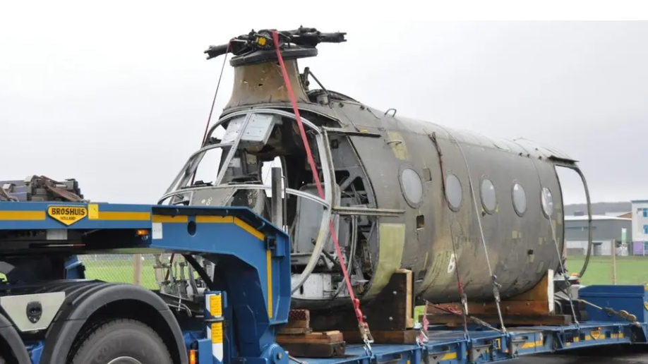 The wrecked skeleton of the front half of the Flying Banana, being transported on an articulated lorry