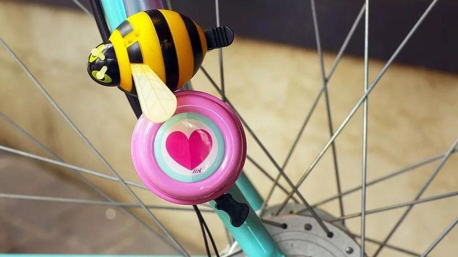 A bee and a heart on the inner arch of a bike tyre