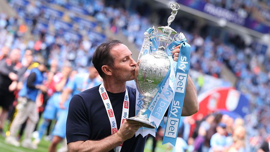 Frank Lampard kisses the Championship trophy after the match between Coventry City and Wrexham in April 2026.