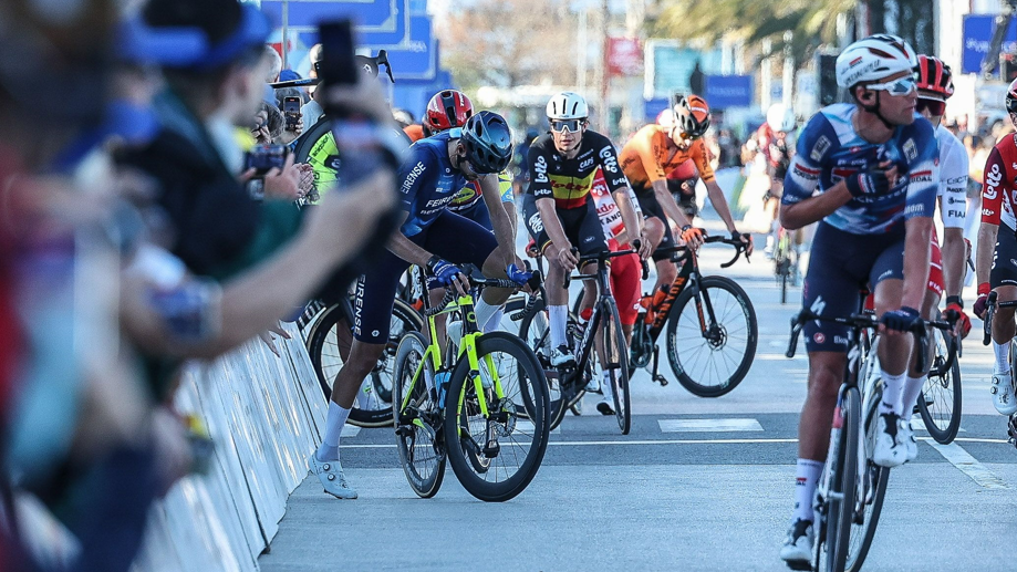 Cyclists react after dozens of riders missed the finish line after confusion towards the end of the first stage of the Volta ao Algarve 