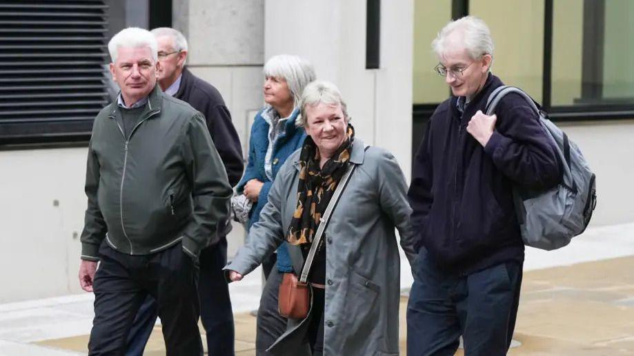 Some of the family members of those who were killed in Shoreham Aircrash walking along street together
