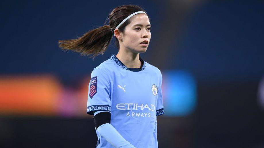 Yui Hasegawa walking on the pitch in Man City's light blue kit